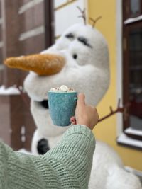 Close-up of hand holding stuffed toy