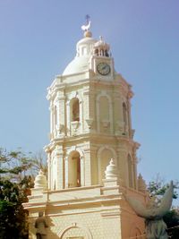 Low angle view of bell tower against sky