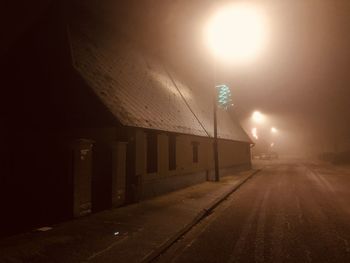 View of illuminated street lights at night