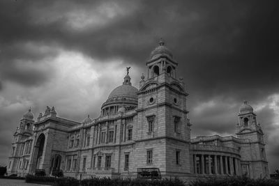 Low angle view of building against cloudy sky