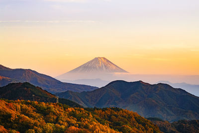 Scenic autumn view of mt. fuji against sky during sunset