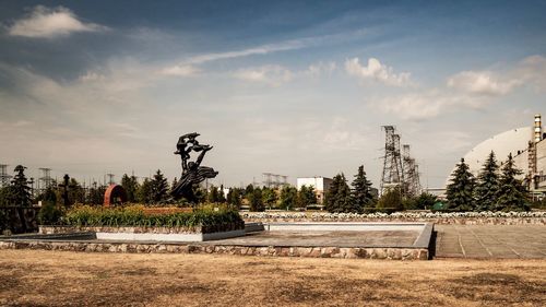 Sculpture on field against sky