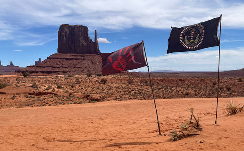 Scenic view of desert with flags