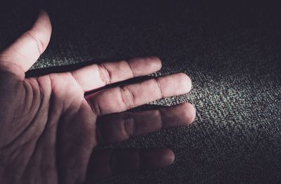 Close-up of hand on fabric