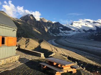 Scenic view of snowcapped mountains against blue sky