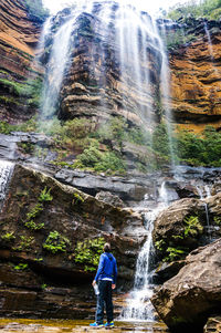 Man looking at katoomba falls against sky