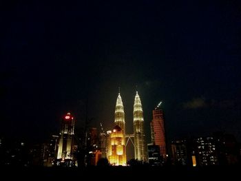 Low angle view of skyscrapers lit up at night