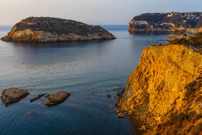 Scenic view of rock formation in sea against sky