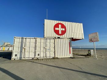Road sign against clear blue sky