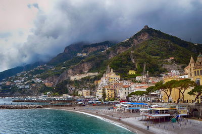 Panoramic shot of sea and buildings against sky