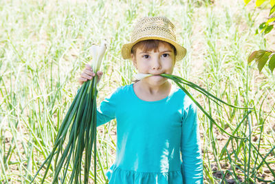 Portrait of young woman holding plant