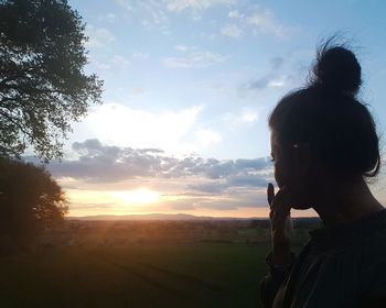 Portrait of man standing against sky during sunset