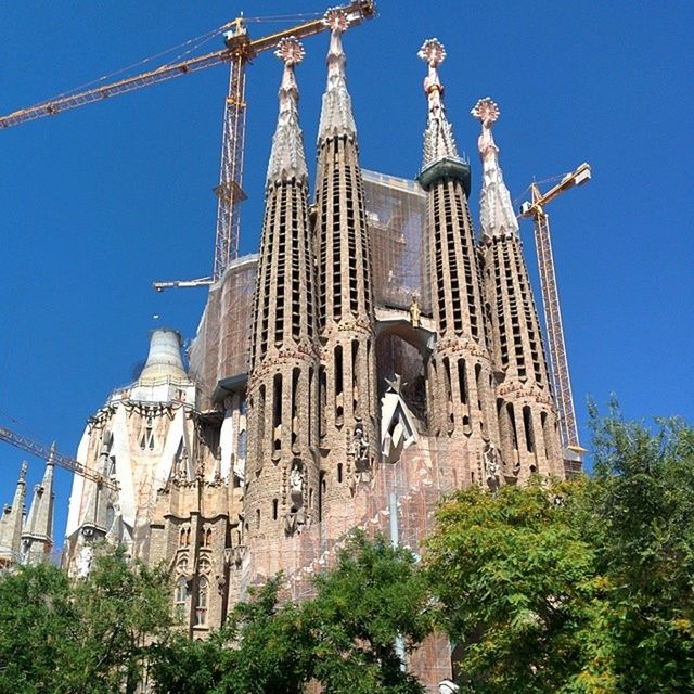 religion, place of worship, architecture, building exterior, built structure, spirituality, church, cathedral, low angle view, clear sky, steeple, cross, history, blue, famous place, travel destinations, old, sky