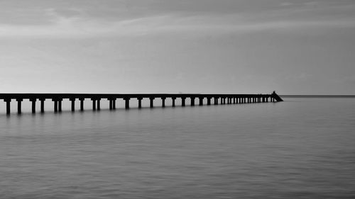 Pier over sea against sky