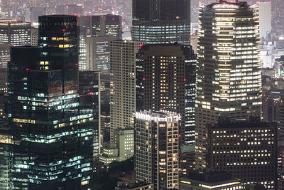 High angle view of city lit up at night