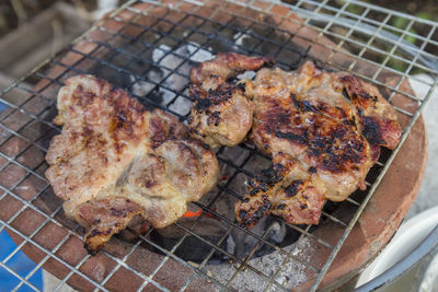 Burn grill meat on stove with burning charcoal