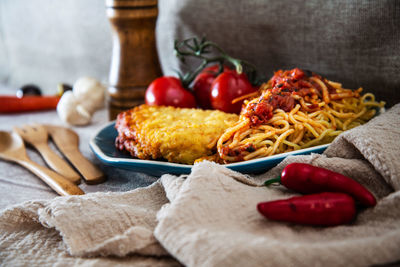 Close-up of food in plate by napkin on table