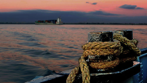 Close-up of rope tied to fishing at sunset