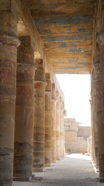 Columns in karnak temple with remaining clue color paint on ceiling in luxor egypt