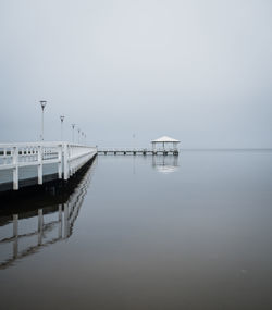 Pier over sea against clear sky