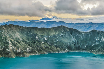 Scenic view of sea and mountains against sky