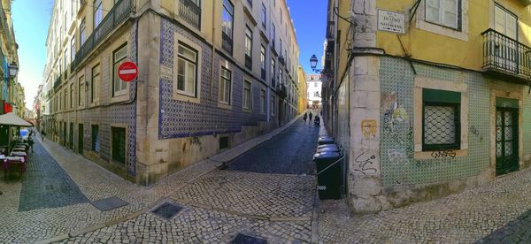 Street amidst buildings against sky in city