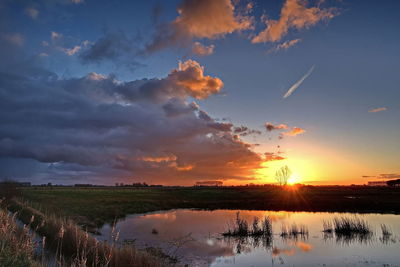 Scenic view of field against sky during sunset