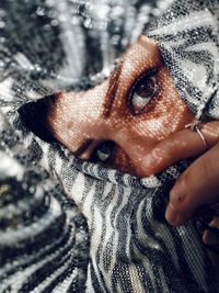 Close-up portrait of woman with snow covered face