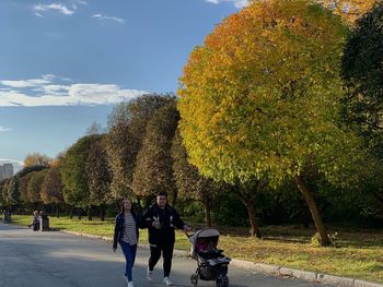 Rear view of people walking on road