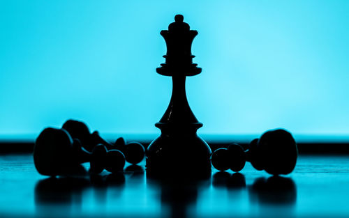 Close-up of chess pieces against blue background