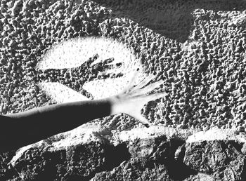 Close-up of hand on sand