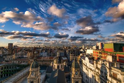 Cityscape against cloudy sky