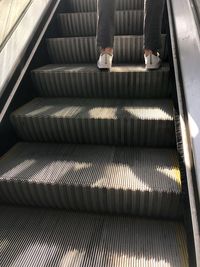 Low section of man on escalator