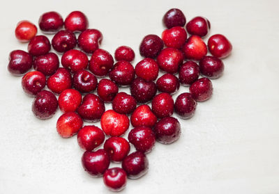 Close-up of red fruit over white background
