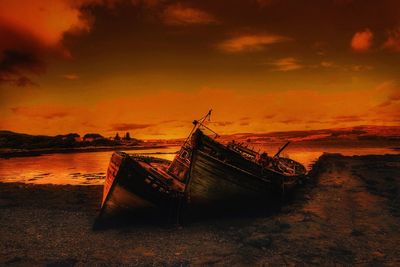 Boats in sea at sunset