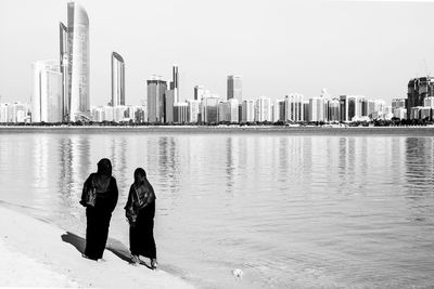 Muslim women standing on beach