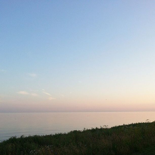 sea, horizon over water, tranquil scene, water, tranquility, scenics, beauty in nature, copy space, clear sky, beach, nature, idyllic, sky, shore, sunset, remote, outdoors, calm, coastline, non-urban scene