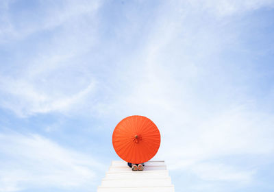 Low angle view of red balloons against sky