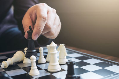 Midsection of man playing chess