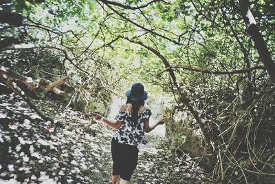 Woman standing by tree