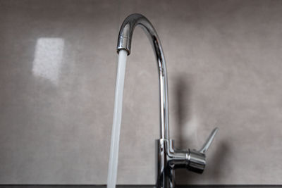 Close-up of faucet in bathroom