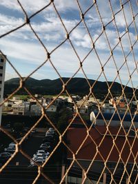 Close-up of chainlink fence against sky