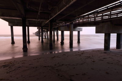 Low angle view of pier on beach 