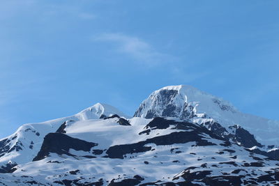 Scenic view of snow covered mountains against sky