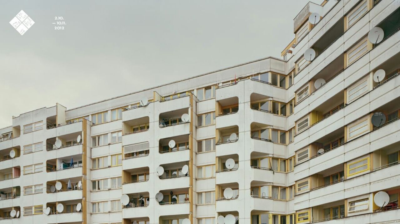 architecture, building exterior, built structure, low angle view, city, window, building, modern, office building, clear sky, skyscraper, tall - high, residential building, tower, apartment, sky, day, residential structure, in a row, city life