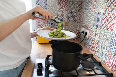 Midsection of woman having food at home