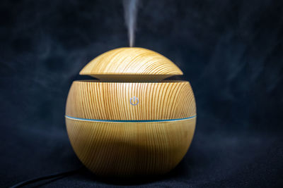 Close-up of illuminated electric lamp on table