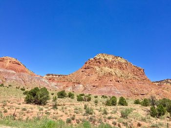 Scenic view of rocky mountains against clear blue sky