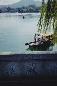 People sitting on riverbank by river