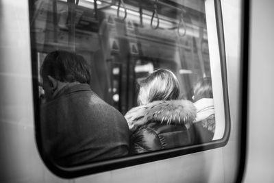 Rear view of people sitting in train